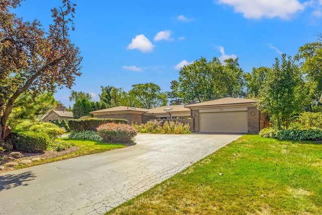 ranch-style home with a front yard and a garage