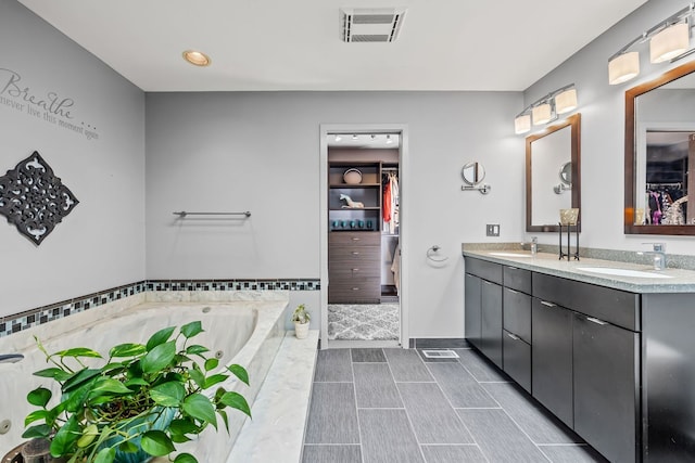 bathroom with vanity and a bath