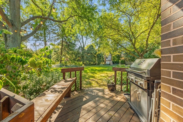 deck featuring a lawn and a grill