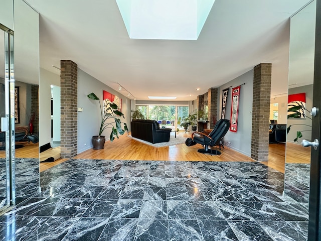 interior space with hardwood / wood-style flooring and ornate columns