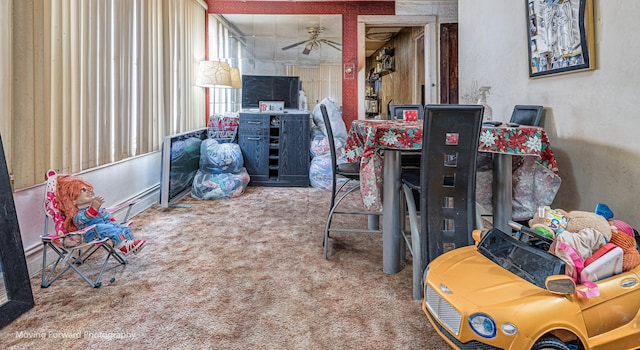 interior space with ceiling fan and carpet flooring