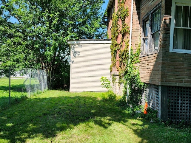 6926 S Vernon Ave, Chicago, IL 60637 - view of side of property featuring a yard, stone siding, and fence