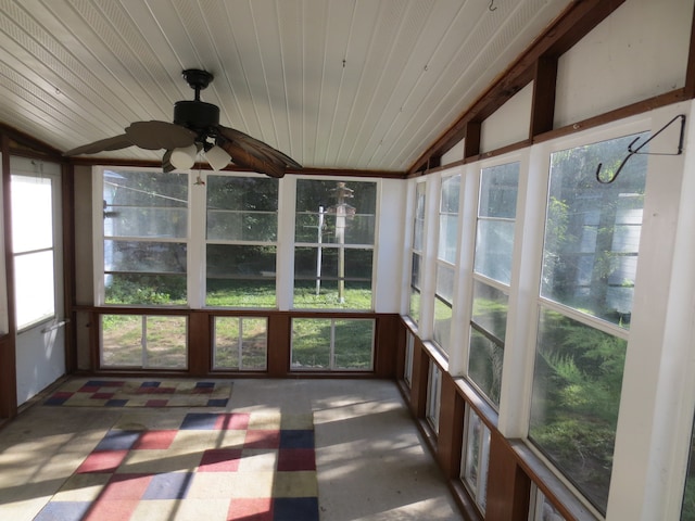 unfurnished sunroom with wood ceiling, lofted ceiling, ceiling fan, and plenty of natural light