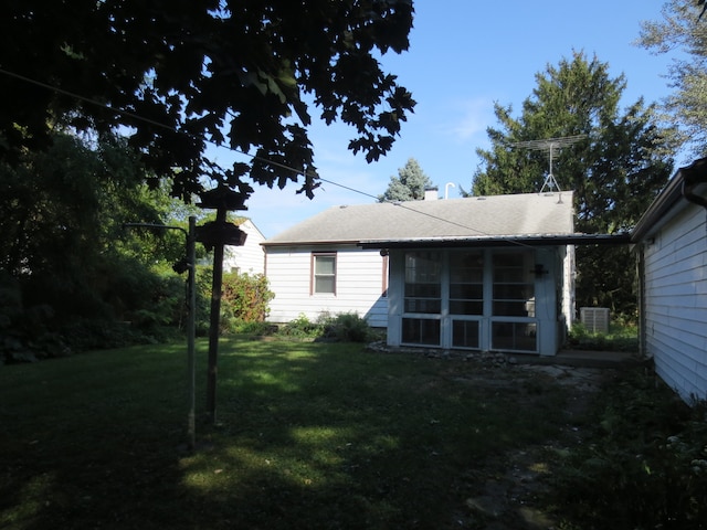 back of house with a lawn