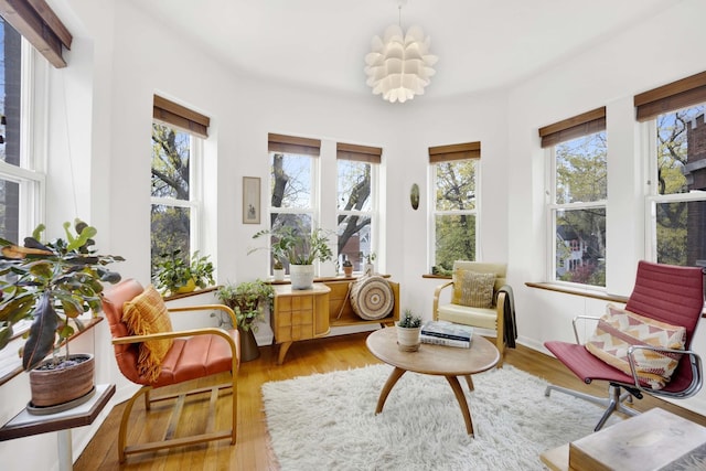 sunroom / solarium with a chandelier