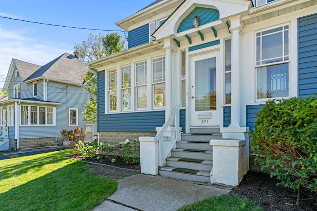 doorway to property featuring a yard