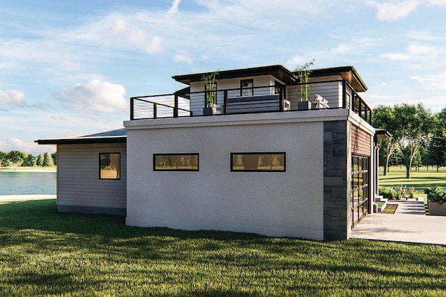 view of side of home with a balcony, a water view, and a lawn