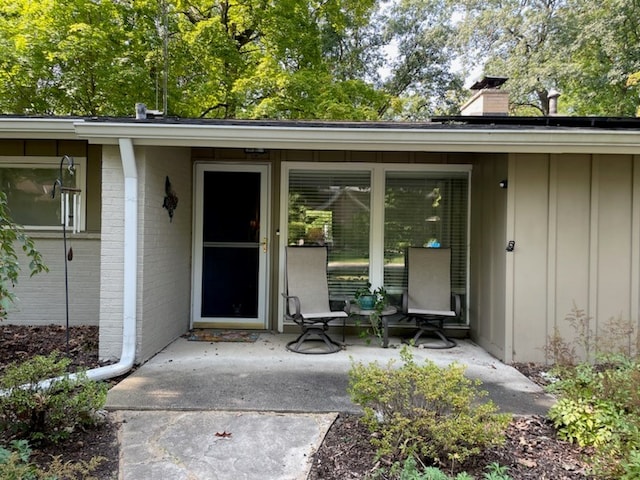 view of exterior entry featuring a patio