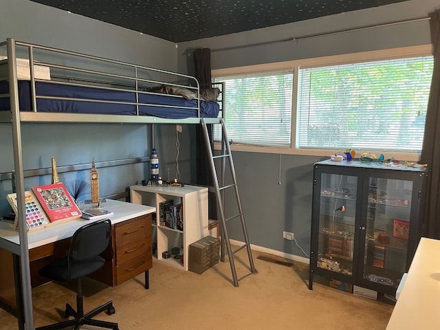 carpeted bedroom featuring multiple windows