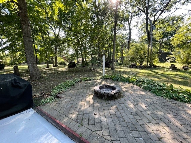 view of patio / terrace with a fire pit and grilling area