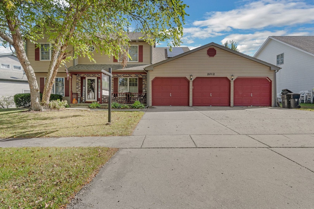 view of front of property with a garage and a front yard