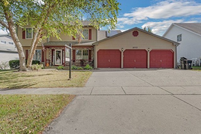 view of front of property with a garage and a front yard