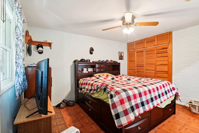 bedroom featuring parquet flooring and ceiling fan