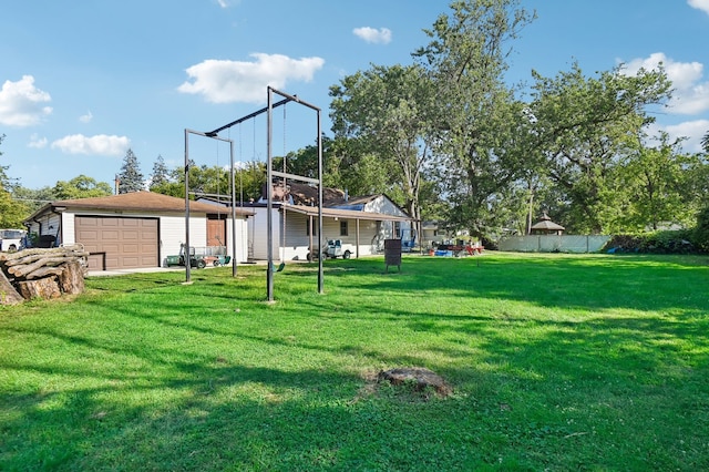 view of yard featuring a garage and an outbuilding