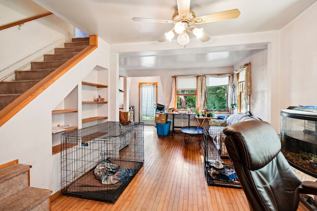 living room with hardwood / wood-style flooring and ceiling fan