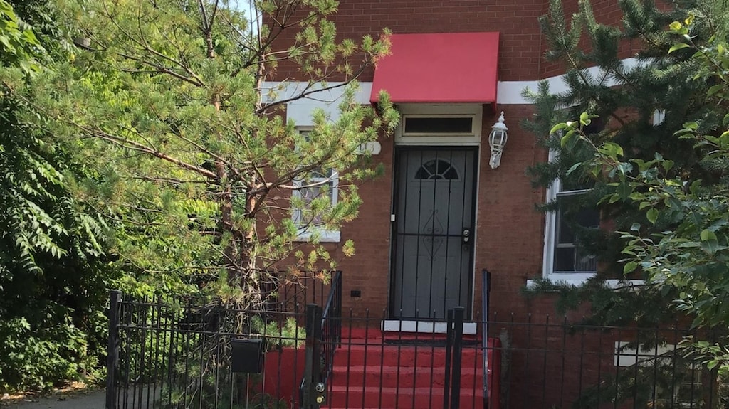 1113 S Saint Louis Ave, Chicago, IL 60624 - view of exterior entry featuring brick siding and a gate