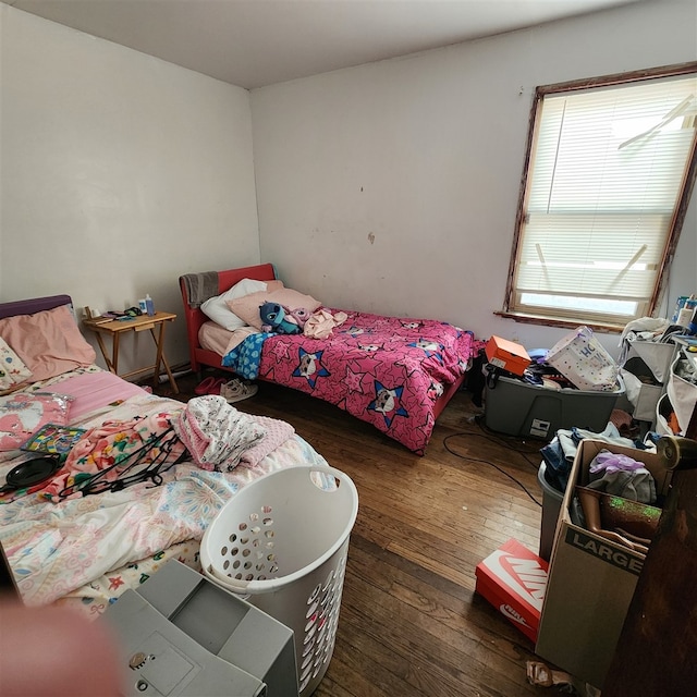 bedroom with dark wood-type flooring