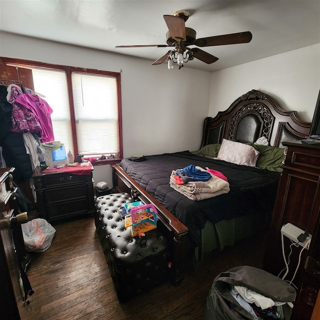 bedroom with ceiling fan and dark hardwood / wood-style floors