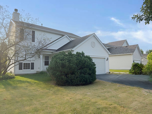 view of side of property featuring a garage and a lawn