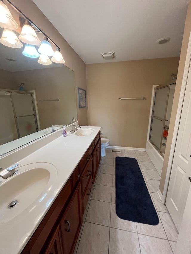 full bathroom featuring tile patterned flooring, toilet, combined bath / shower with glass door, and vanity