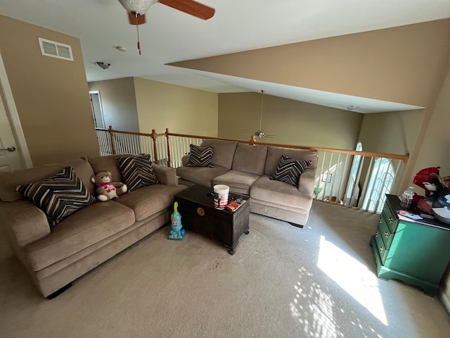 carpeted living room with lofted ceiling and ceiling fan