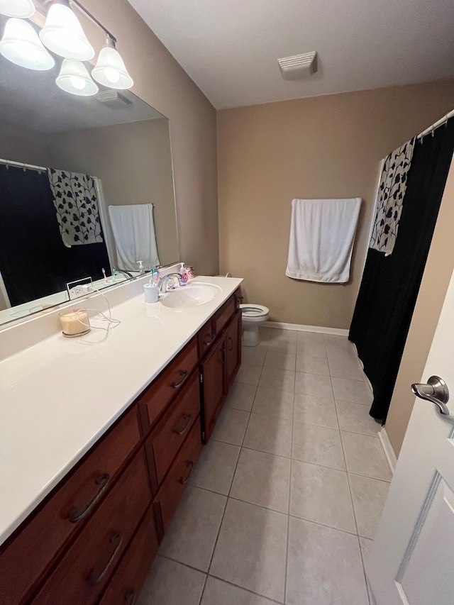 bathroom featuring tile patterned floors, toilet, an inviting chandelier, and vanity