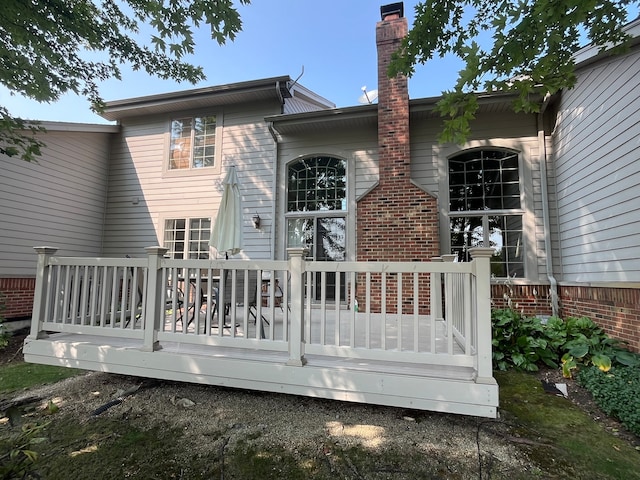 rear view of house featuring a wooden deck