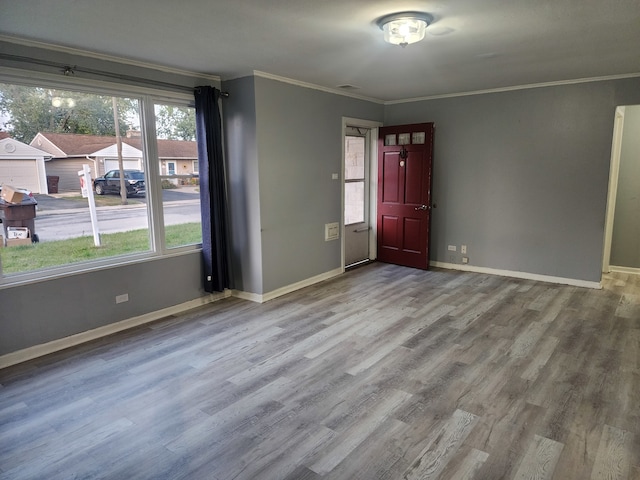 unfurnished room featuring crown molding and hardwood / wood-style flooring