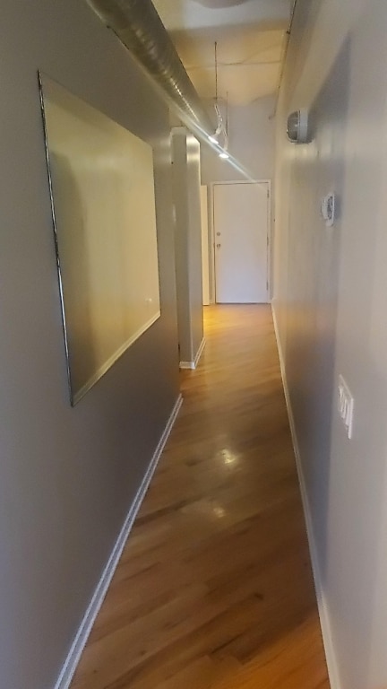 hall with hardwood / wood-style flooring