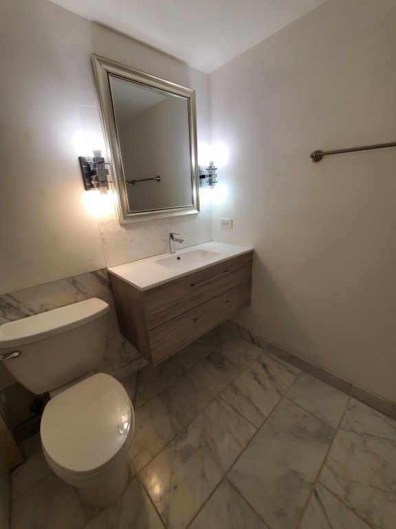 bathroom with toilet and vanity