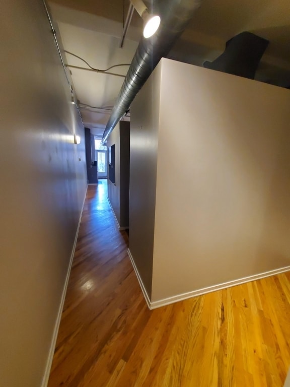 corridor with wood-type flooring