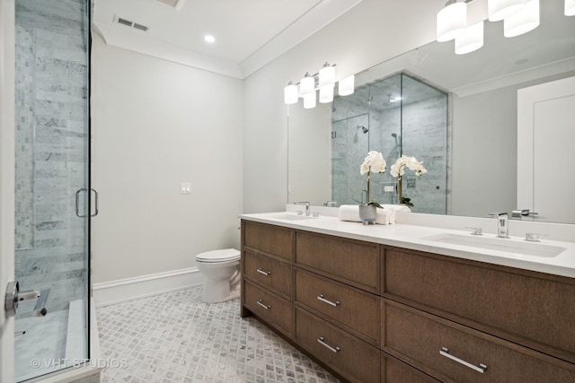 bathroom featuring a shower with door, vanity, crown molding, and toilet