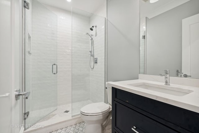 bathroom featuring vanity, tile patterned floors, a shower with door, and toilet