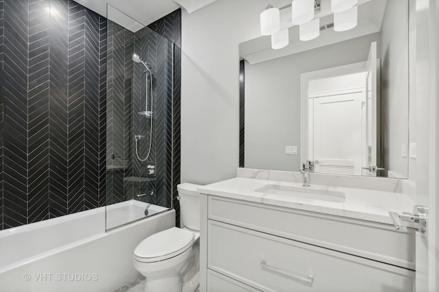 full bathroom featuring tiled shower / bath combo, vanity, and toilet