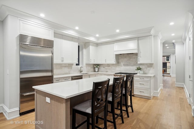 kitchen featuring white cabinetry, a kitchen island, and appliances with stainless steel finishes