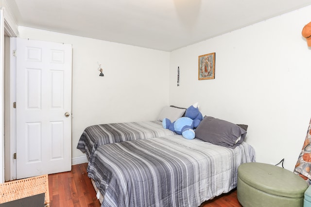 bedroom with dark hardwood / wood-style flooring