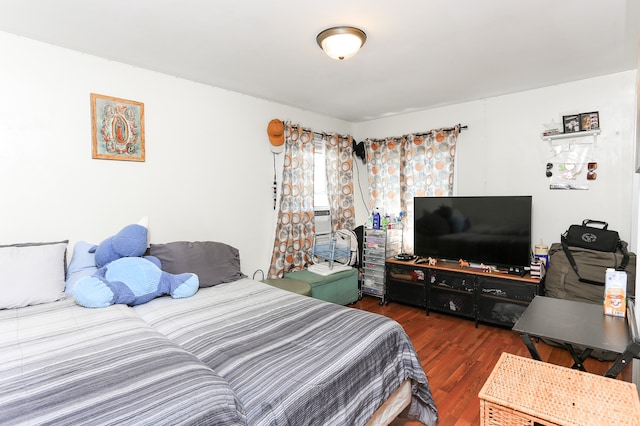 bedroom with hardwood / wood-style flooring