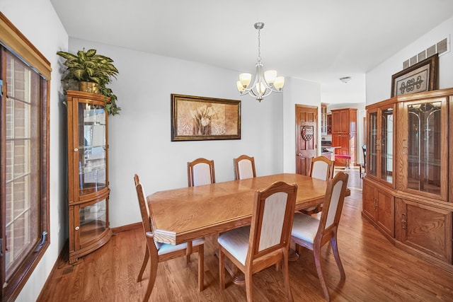 dining area featuring a chandelier and light wood-type flooring