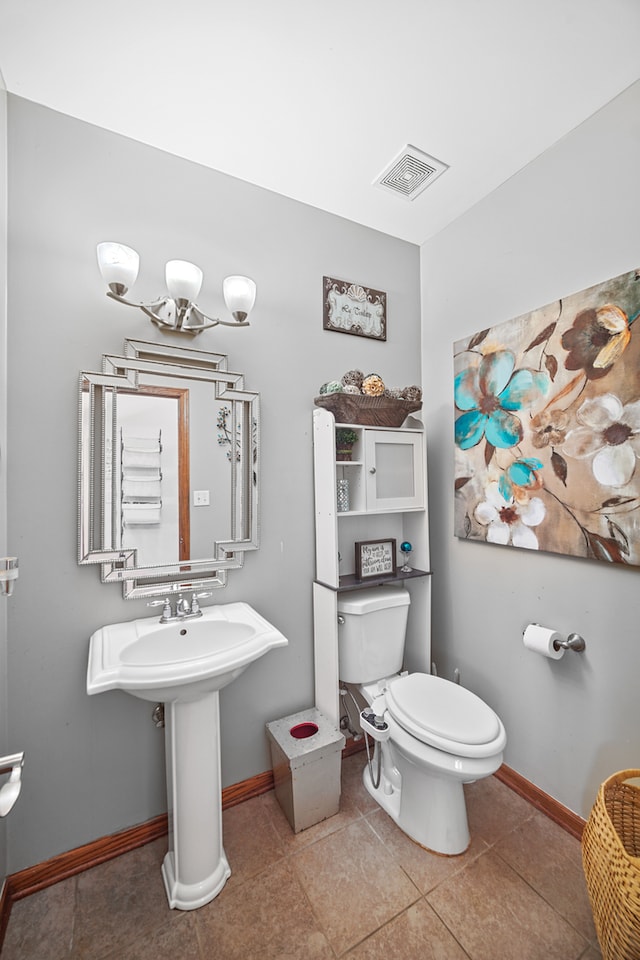 bathroom with toilet and tile patterned flooring