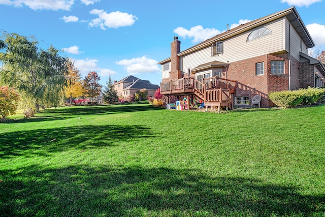 back of house with a yard and a wooden deck