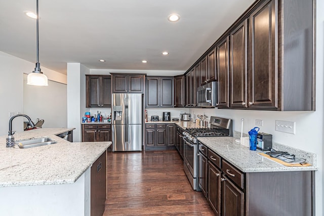 12740 Timber Wood Cir, Plainfield, IL 60585 - kitchen featuring appliances with stainless steel finishes, a sink, dark brown cabinetry, dark wood-type flooring, and recessed lighting