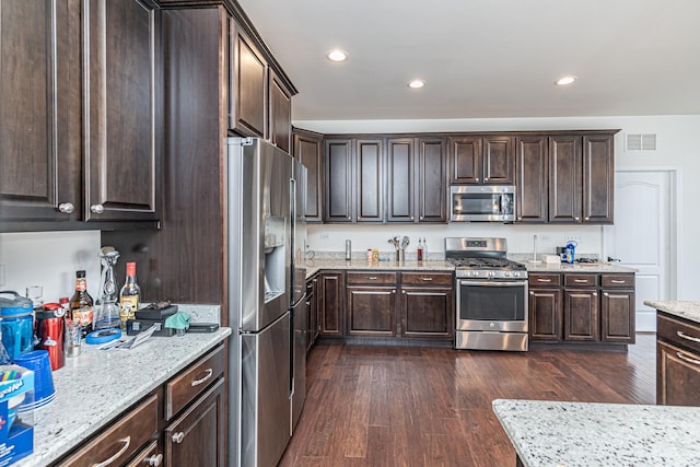12740 Timber Wood Cir, Plainfield, IL 60585 - kitchen featuring appliances with stainless steel finishes, dark brown cabinets, dark wood-type flooring, and recessed lighting
