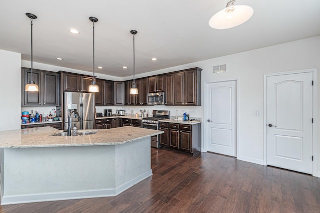 12740 Timber Wood Cir, Plainfield, IL 60585 - kitchen featuring appliances with stainless steel finishes, a sink, dark wood-style floors, dark brown cabinetry, and light stone countertops