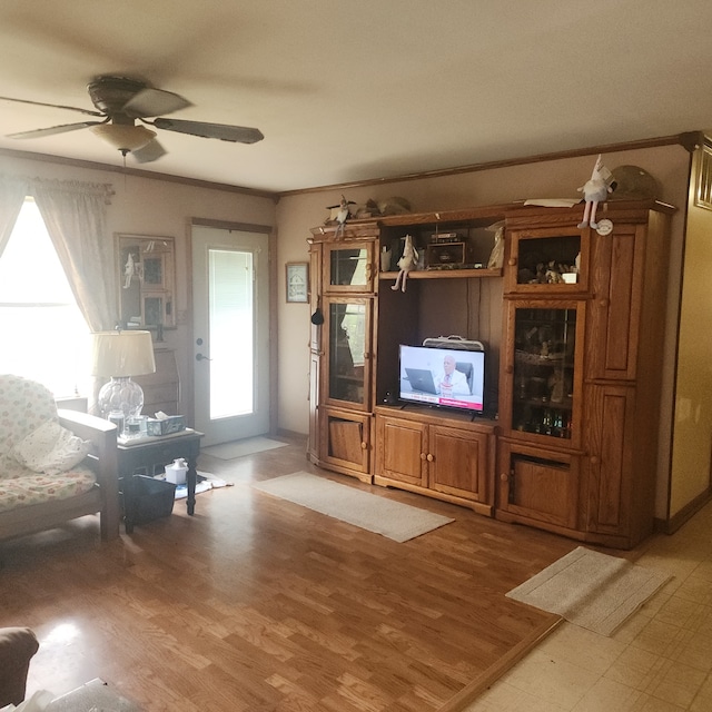 unfurnished living room with ceiling fan, light hardwood / wood-style floors, and ornamental molding