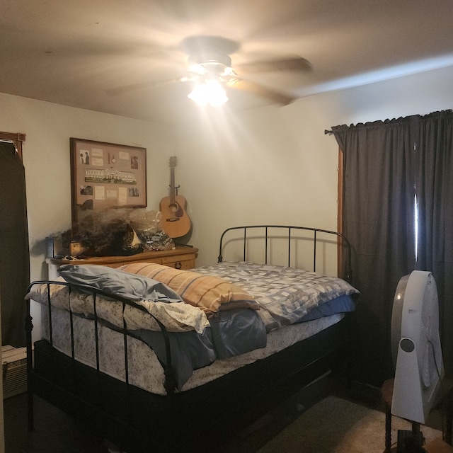 bedroom featuring ceiling fan and carpet