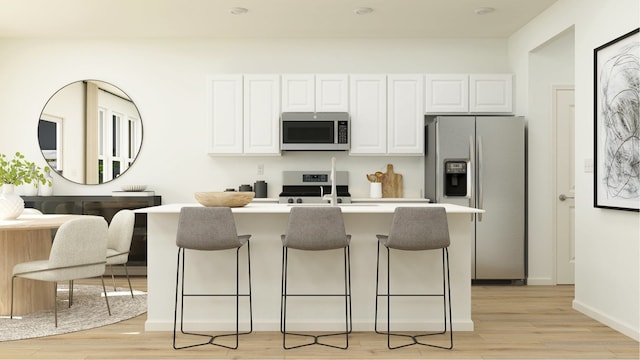 kitchen featuring a breakfast bar area, sink, white cabinets, and stainless steel appliances