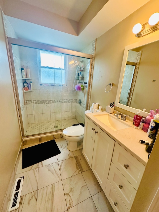 bathroom with vanity, toilet, and an enclosed shower