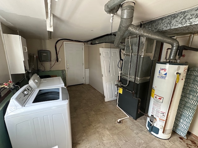 laundry area featuring water heater, heating unit, separate washer and dryer, and cabinets