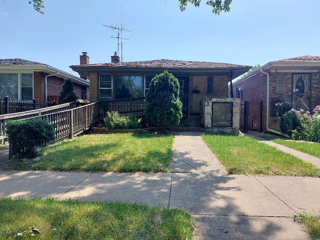 bungalow-style house with a front yard