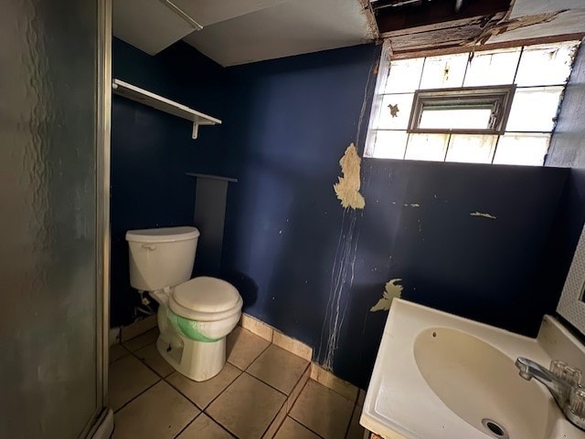 10809 S Mackinaw Ave, Chicago, IL 60617 - full bath with tile patterned flooring, a sink, baseboards, toilet, and a shower with door